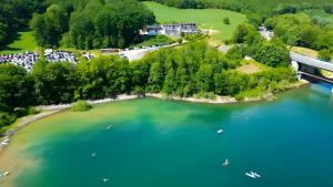 an aerial view of a resort on a lake at Schnütgenhof Appartements in Attendorn