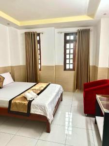 a bedroom with a bed and a red chair at HoTeL Long Phụng 1 Quận Bình Tân in Ho Chi Minh City +37 photos