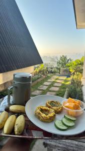 a plate of food and fruit on a table at Payas Private Farm Villa in Praya
