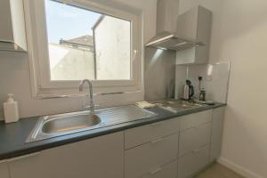 a kitchen with a sink and a window at Edinburgh Shore Apartments in Edinburgh