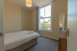 a bedroom with a bed and a window at Edinburgh Shore Apartments in Edinburgh
