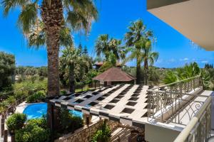 a view from the balcony of a villa with palm trees at Popi's apartment in Argostoli