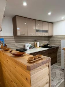 a kitchen with a wooden counter top in a room at Apartman Bakic in Kolašin