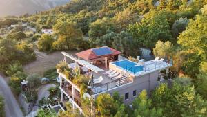 an aerial view of a house with a swimming pool at Villa Dobric Apartments in Kavač