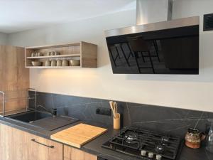 a kitchen with a stove and a counter top at Le prélong in Murol