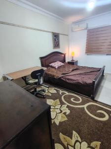 a bedroom with a bed and a desk and a desk at شقة14 in Irbid