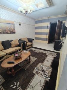 a living room with a couch and a table at شقة14 in Irbid