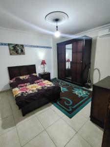 a bedroom with a bed and a rug at شقة14 in Irbid