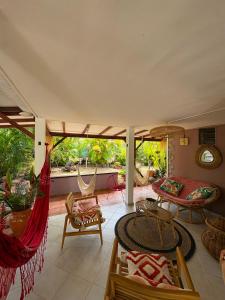 a living room with a hammock and a patio at Gite d'Arles "Villa Doudou" in Le Moule
