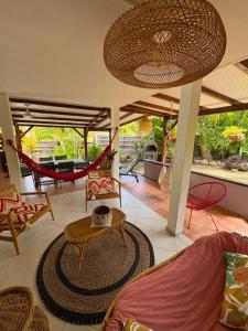 a living room with a hammock and a patio at Gite d'Arles "Villa Doudou" in Le Moule