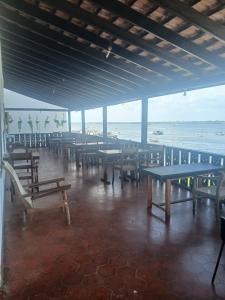 a room with tables and chairs and the ocean at Lamu Sunsail Hotel in Lamu