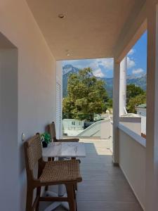 a dining room with a table and chairs on a balcony at Ester Luxury Rooms in Skala Potamias