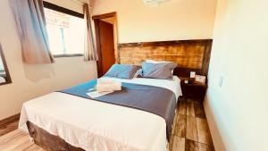 a small bedroom with a bed and a window at Pousada Flor de Pequi in Serra do Cipo