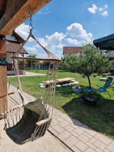 a hammock swing in a yard with a patio at CASA ȘINCU in Cristian