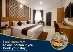 a hotel room with a bed and a plate of food at Aneks Ibro Hotel, Wuse Zone 5, Abuja in Abuja