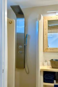 a shower in a small bathroom with a sink at Sul Mare Suite in Agia Kiriaki Beach +34 photos