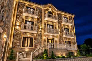 a large stone building with stairs and lights at Makaryan Resort in Artsvaberd