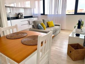 a kitchen and living room with a table and a couch at Apartamento T1 - MedSal Residence in Santa Maria