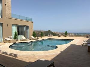 a swimming pool in the backyard of a house at Dar Zaha in Aguenouane