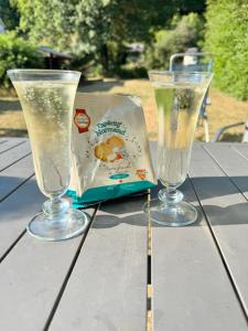 two glasses sitting on top of a table at L écrin de l aube in Grainville-la-Teinturière