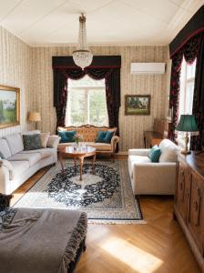 a living room with a couch and a table at Källgård in Lohja