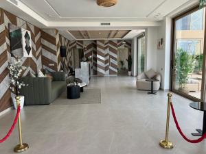 a living room with a lobby with a red ribbon at Dar Zaha in Aguenouane