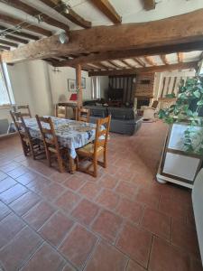 a dining room with a table and chairs at L écrin de l aube in Grainville-la-Teinturière +14 photos