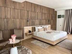 a bedroom with a large bed and wooden walls at Dar Zaha in Aguenouane +19 photos