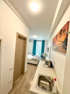 a kitchen with a sink and a living room at Summerland Seaview Premium Apartments in Mamaia +143 photos