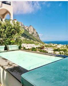 a swimming pool with a view of the ocean at Al Capri Suite & Private Pool in Capri
