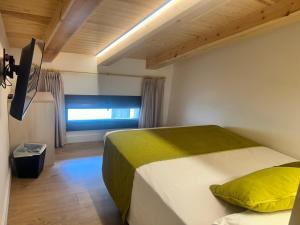 a bedroom with two beds and a window at Hotel SAIOLA in Camprodon