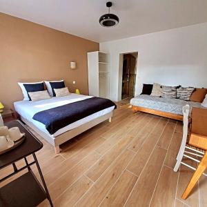 a bedroom with a large bed and a desk at Domaine de la gare M - anciennement Logis de La Garenne in Mortagne-sur-Gironde +143 photos