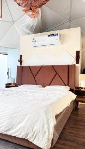a bedroom with a bed with a air conditioner on the wall at سكون in Al Baha +9 photos