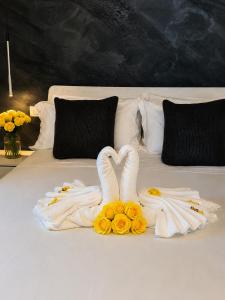 two swans made out of towels on a bed at Athos Hotel in Riva del Garda