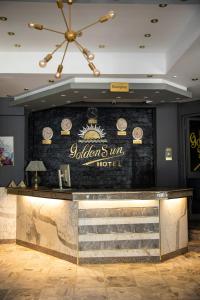 a bar in a hotel with a sign on a wall at Golden Sun Hotel - Hurghada in Hurghada