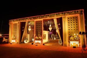a building covered in christmas lights at night at Crystal Park Hotel And Restaurant in Lalru
