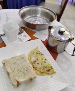 a white plate with two slices of bread on a table at Six Diamond Hotel in Ikeja