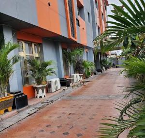 an empty street with palm trees in front of a building at Six Diamond Hotel in Ikeja