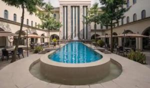 a large swimming pool in front of a building at Six Diamond Hotel in Ikeja