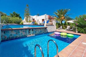 a swimming pool in a villa with a resort at Thodorou Sunset Villa in Stalos