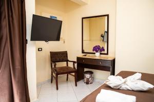 a hotel room with a desk and a mirror at Golden Sun Hotel - Hurghada in Hurghada