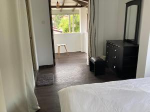 a bedroom with a bed and a dresser and a mirror at My Place Sri Lanka CMB Near Airport in Katunayaka