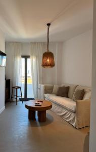 a living room with a couch and a table at Almond Chambers in Naousa
