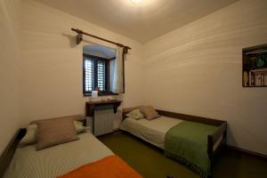 a bedroom with two beds and a window at Dalmatian Stone House in Baška Voda