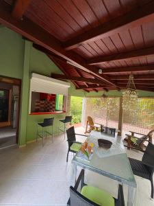 a living room with a table and chairs at Gite d'Arles Bungalow "Orchidée" in Le Moule