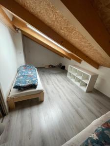 an attic room with a bed and a loft at Apartmán na Břehách in Veselí nad Moravou