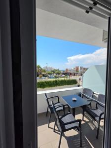 a balcony with chairs and a table and a view at Seahorse in Ksamil