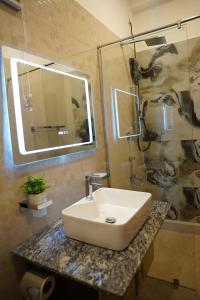 a bathroom with a sink and a shower at Harbour Front Villa in Trincomalee