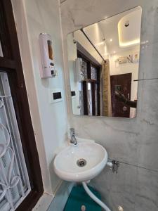 a bathroom with a sink and a mirror at TEMPLE VIEW GUEST HOUSE in Hampi +56 photos