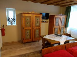 a living room with a table and wooden furniture at Zantnhof in Röhrabrunn